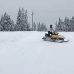 A snowmachine travels down a trail along Kalifornsky Beach Road on Tuesday, Feb. 18, 2020, near Kenai, Alaska. (Photo by Victoria Petersen/Peninsula Clarion)