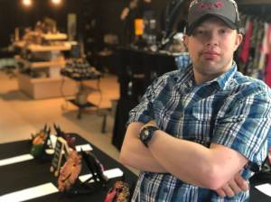 Victoria Petersen / Peninsula Clarion                                 Ethan Satterwhite stands near a clay mask he created in an art class at Hope Community Resources in Soldotna.