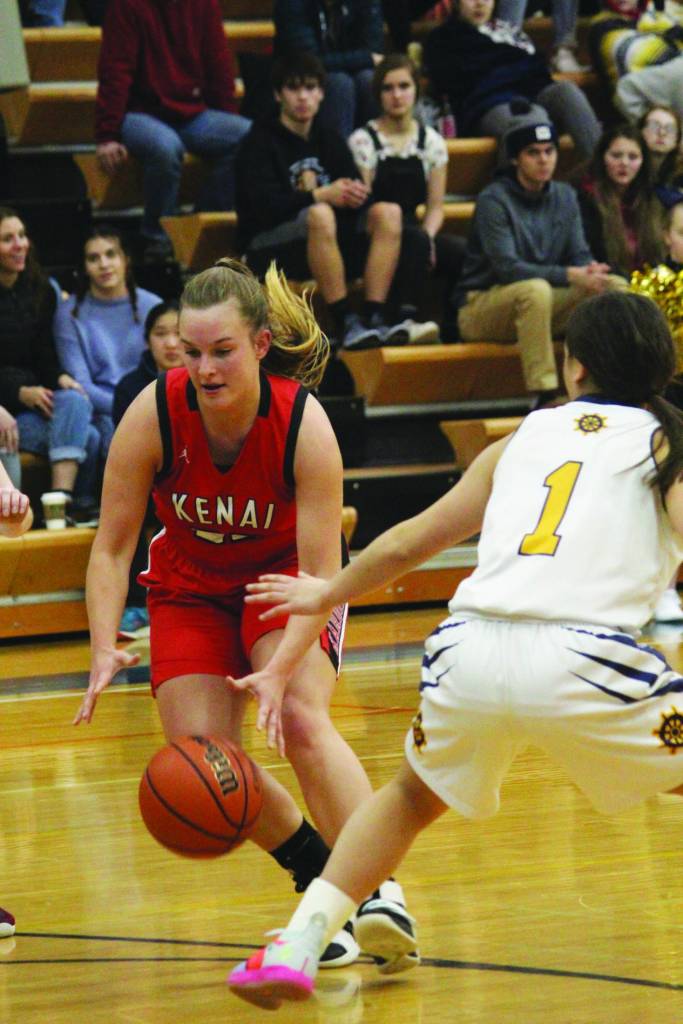 Kenais Jaiden Streiff dribbles past Homers Sailey Rhodes during a Wednesday, Feb. 19, 2020 basketball game at Homer High School in Homer, Alaska. (Photo by Megan Pacer/Homer News)