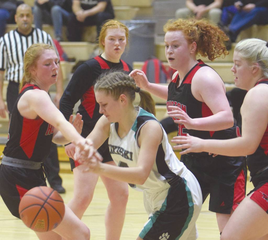 Nikiskis Elora Reichert tries to evade the pressure of Houstons Denali Whitted, Anna Whitted, Emily Bitler and Hanna Elson on Friday, Feb. 21, 2020, at Nikiski High School in Nikiski, Alaska. (Photo by Jeff Helminiak/Peninsula Clarion)