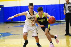 Homers Clayton Beachy pressures Redingtons Tony Rogers during a Friday, Feb. 21, 2020 basketball game in the Alice Witte Gymnasium in Homer, Alaska. (Photo by Megan Pacer/Homer News)