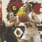 Kenais Damaris Severson passes under pressure from Grace Christians Julia Tanner on Friday, Feb. 21, 2020, at Kenai Central High School in Kenai, Alaska. (Photo by Ben Boettger/For the Clarion)