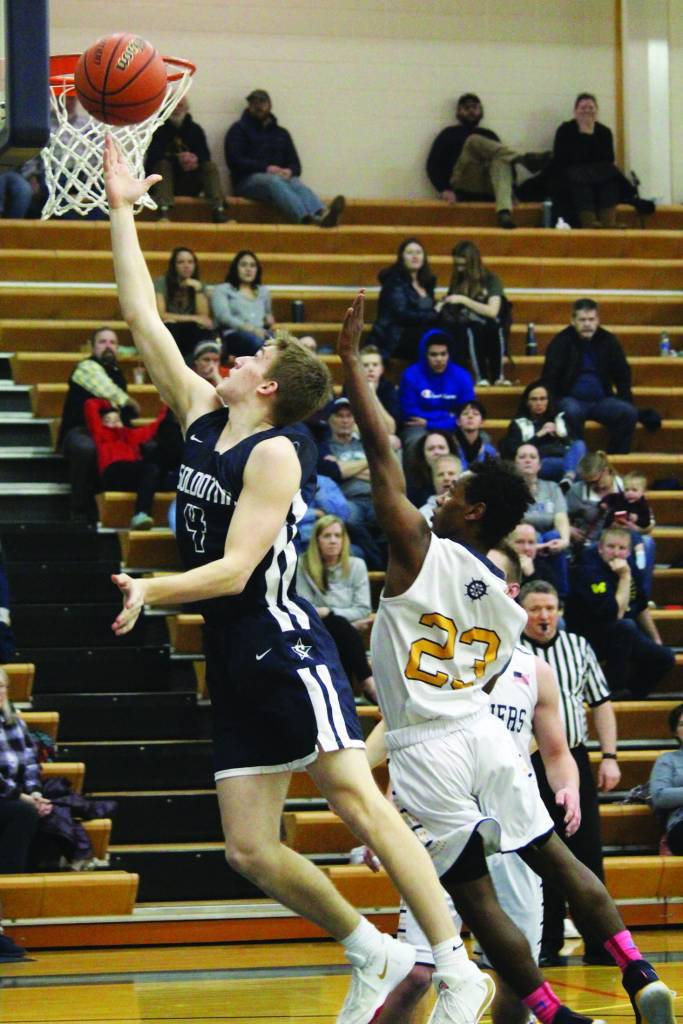 Homers Eyoab Knapp follows Soldotnas Tyler Morrison as he goes up for a basket during a Tuesday, Feb. 25, 2020 basketball game in the Alice Witte Gymnasium in Homer, Alaska. (Photo by Megan Pacer/Homer News)