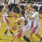 Sewards Max Pfeiffenberger looks to pass around Kenais Braedon Pitsch (31) and the Kenai defense Friday, Feb. 28, 2020, at Kenai Central High School in Kenai, Alaska. (Photo by Jeff Helminiak/Peninsula Clarion)