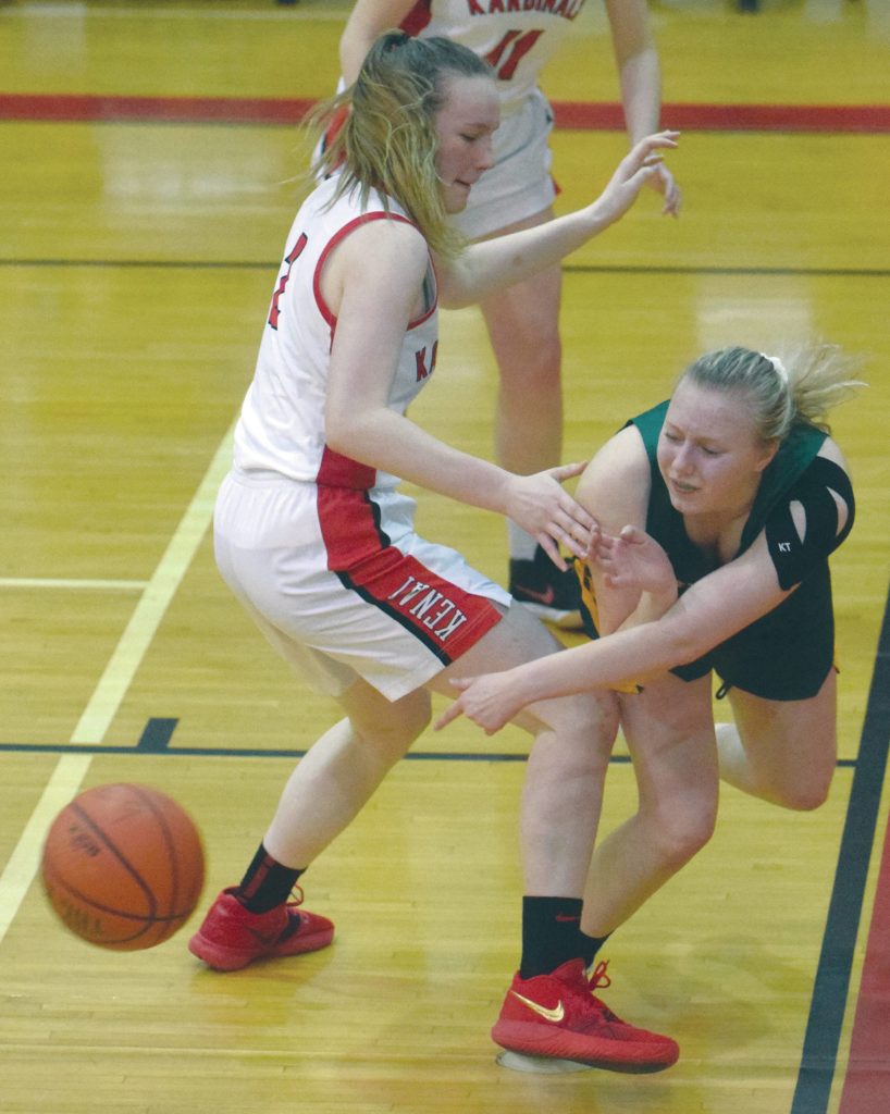 Sewards Katelyn Lemme passes around Kenais Bethany Morris on Friday, Feb. 28, 2020, at Kenai Central High School in Kenai, Alaska. (Photo by Jeff Helminiak/Peninsula Clarion)