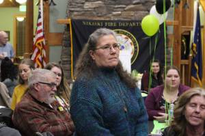 Brian Mazurek / Peninsula Clarion                                 Wildwood Correctional Officer Amy Fisher listens as the Nikiski Fire Department honors the first responders who played a part in saving her life last October during the Nikiski Fire Departments 2019 Award Ceremony at the Nikiski Senior Center on Feb. 28.                                Wildwood Correctional Officer Amy Fisher listens as the Nikiski Fire Department honors the individuals who played a part in saving her life last October during the Nikiski Fire Departments 2019 Award Ceremony in the Nikiski Senior Center on Feb. 28, 2020. (Photo by Brian Mazurek/Peninsula Clarion)