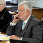 Alaska state Sen. Gary Stevens, right, listens during a Legislative Council meeting on Tuesday, March 10, 2020, in Juneau, Alaska. Stevens on Tuesday announced a subcommittee of lawmakers will work on contingency planning for the Legislature surrounding the new coronavirus. (AP Photo/Becky Bohrer)