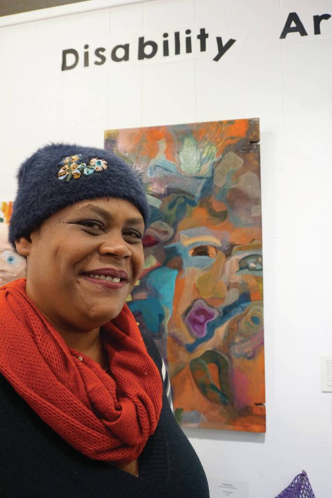 Sadie Mae Millard stands by her art on March 6, 2020, at the Disability Art Show at the Homer Council on the Arts in Homer, Alaska. (Photo by Michael Armstrong/Homer News)