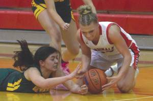 Sewards Anevay Ambrosiani and Sequoia Sieverts fight with Kenais Damaris Severson for the ball Friday, Feb. 28, 2020, at Kenai Central High School in Kenai, Alaska. (Photo by Jeff Helminiak/Peninsula Clarion)