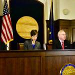 House Speaker Rep. Bryce Edgmon, I-Dillingham, seated, speaks with other members of the House during an at ease on Monday, March 16, 2020. (Peter Segall | Juneau Empire)