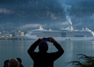 Michael Penn | Juneau Empire File                                A cruise ship passenger photographs a ship in Juneaus downtown harbor in August 2017.