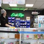 Mariah Schloeman wipes down the counter at East Rip in Kenai, Alaska on March 25, 2020. The store has implemented more stringent cleaning protocols, including wiping down surfaces after every transaction, in the wake of the coronavirus pandemic. (Photo by Brian Mazurek/Peninsula Clarion)