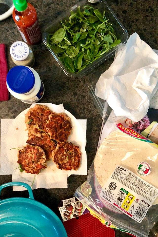 Use whats in your kitchen to whip up delicious, creative meals. Salmon, greens, an assortment of spices and condiments can be used to make patties that will go inside a wrap or a pasta bowl. (Photo by Victoria Petersen/Peninsula Clarion)
