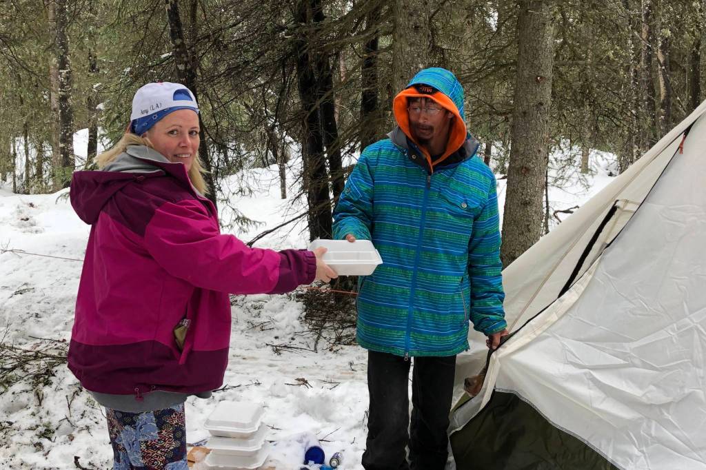 Amy Lynn Burdett Belue, left, delivers a meal to a member of the community experiencing homelessness in this undated photo. (Courtesy Amy Lynn Burdett Belue)