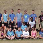 Soldotna cross-country running coach Ted McKenney, standing and far right, poses with his 2019 squad. (Clarion file photo)