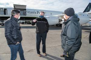 Photo courtesy Office of the Governor                                Gov. Mike Dunleavy (center) speaks with Edward Graham (left) of Samaritans Purse, as two other Samaritans Purse staff members watch. Dunleavy met the crew and staff of the Samaritans Purse DC-8 at Ted Stevens Anchorage International Airport as they offloaded thousands of pounds of medical supplies bound for rural Alaska.