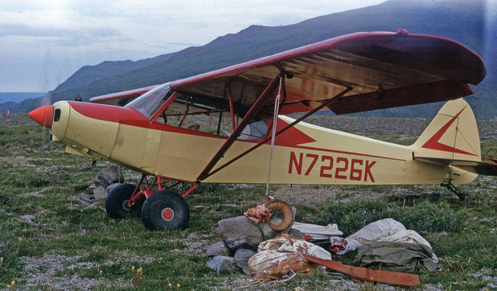 Dan France (in distance) heads for his Super Cub, which is warming up prior to final packing and departure from Tustumena Glacier area, 1963. (Photo courtesy Fair Family Photo Collection)
