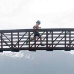 Pyper Dixon crosses a bridge during the Dixon/Holden Memorial Tonsina Beach Trail Run on Wednesday, May 31, 2018, in the Caines Head State Recreation Area in Seward. (Photo by Jeff Helminiak/Peninsula Clarion)