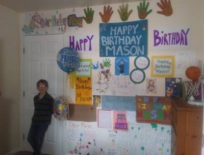 Mason McMilin and the signs his friends and family made for his drive-by birthday in Soldotna, Alaska, on April 10, 2020. (Photo courtesy of Kim McMilin)