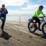 Heather Renner and Tasha Reynolds run and fat bike to the finish line on the Kenai Beach during the 2019 Mouth to Mouth Wild Run & Ride. (Photo courtesy Kaitlin Vadla)