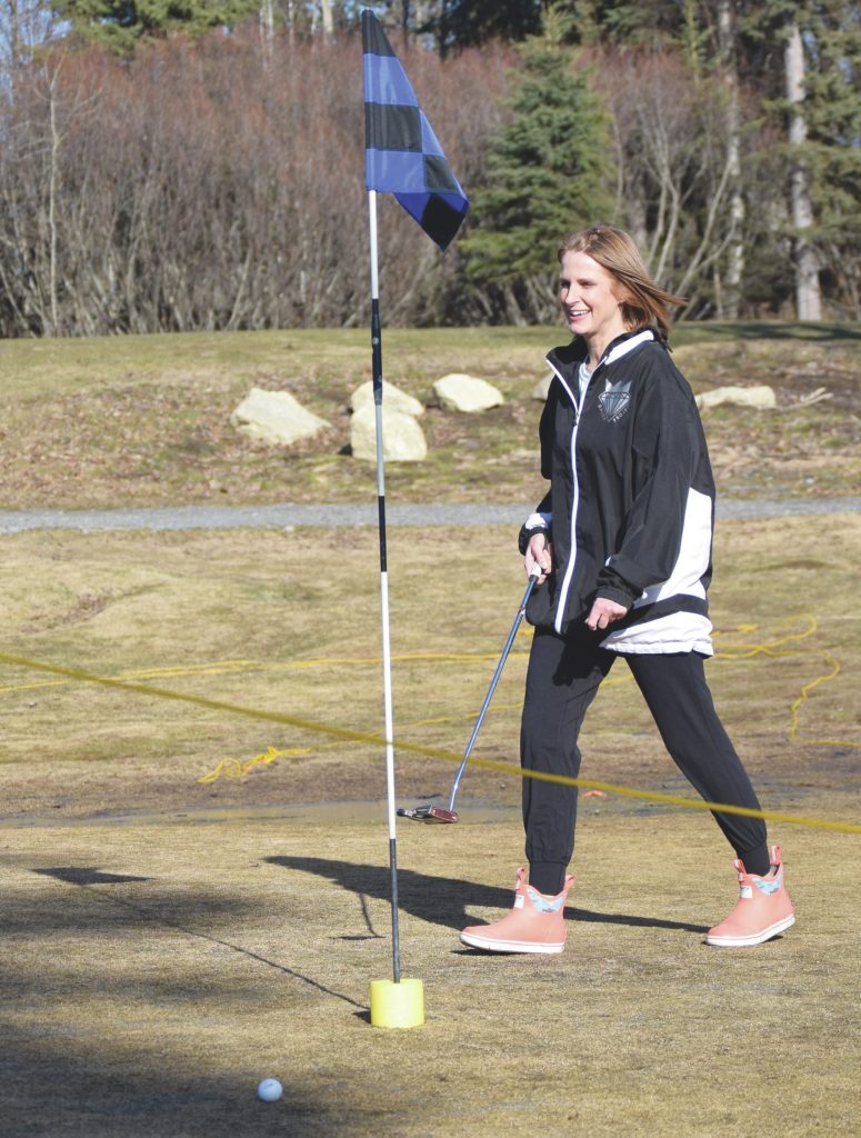 Jeff Helminiak / Peninsula Clarion                                 Kay Downs putts on the second hole Saturday at Birch Ridge Golf Course. Instead of putting the ball in the hole, golfers must hit the yellow noodle.