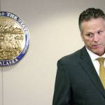 Mark Thiessen / Associated Press file                                Alaska Gov. Mike Dunleavy listens during a news conference in Anchorage on Sept. 26.