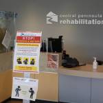 A sign instructing patients and visitors on the COVID-19 screening process is seen in the River Tower of Central Peninsula Hospital in Soldotna, Alaska, on April 7, 2020. (Photo by Brian Mazurek/Peninsula Clarion)