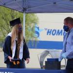 Cameron Blackwell, a graduate and valedictorian of the class of 2020 at Soldotna High School, receives her diploma from principal Tony Graham Soldotna High School in Soldotna, Alaska on May 18, 2020. (Photo by Brian Mazurek/Peninsula Clarion)