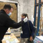 Alaska state Rep. Jennifer Johnston, an Anchorage Republican, gets her temperature taken by Roy Johnston, a captain with Capital City Fire/Rescue, at the state Capitol on Monday, May 18, 2020, in Juneau, Alaska. The Alaska Legislature planned to reconvene Monday to address use of federal coronavirus relief funds, with protocols in place aimed at guarding against the virus. (AP Photo/Becky Bohrer)