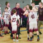 Jeff Helminiak / Peninsula Clarion file                                Nikolaevsk coach Steve Klaich celebrates with his team after winning his first Peninsula Conference title in his 30th season at the helm March 1, 2019, at Cook Inlet Academy in Soldotna.
