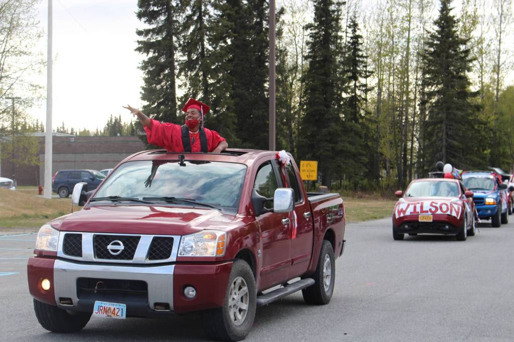 Senior Elijah Royal-Reyna waves to the crowd during the Kenai Central High Schools Class of 2020 Graduation Parade in Kenai, Alaska, on May 20, 2020. (Photo by Brian Mazurek/Peninsula Clarion)