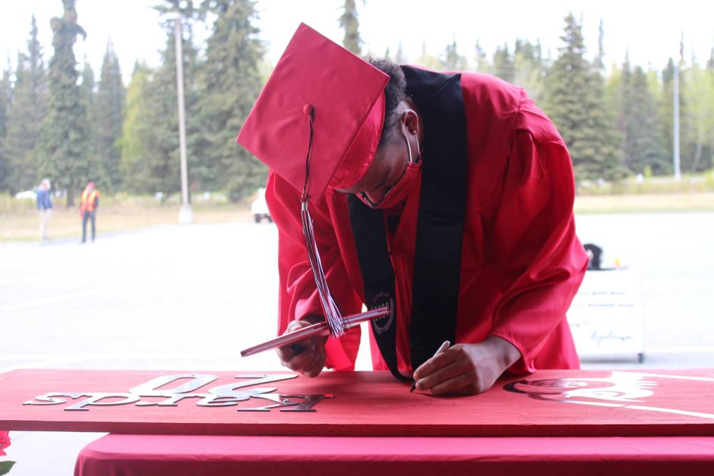 Senior Elijah Royal-Reyna receives his diploma during Kenai Central High Schools Class of 2020 Graduation Parade in Kenai, Alaska, on May 20, 2020. (Photo by Brian Mazurek/Peninsula Clarion)