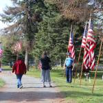 Kenai residents take a moment to honor fallen veterans during the Memorial Day ceremony at the Kenai Cemetery on May 25, 2020. (Photo by Brian Mazurek/Peninsula Clarion)