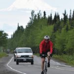 Joey Klecka / Peninsula Clarion                                Anchorages John Krellner rides down Gas Well Road with Mount Redoubt in the background June 9, 2019, in the Tri-The-Kenai Triathlon in Soldotna.