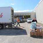 Kenai Peninsula Boys & Girls Clubs CEO Rachel Chaffee, right loads up a pallet with goods that Carlile driver Robert Ivy will take back to Carliles Kenai headquarters, where it will then be transported to Anchorage and ultimately Seward, at Kenai Central High School in Kenai, Alaska on May 28, 2020. (Photo by Brian Mazurek/Peninsula Clarion)