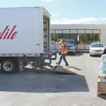 Photo by Brian Mazurek/Peninsula Clarion                                Kenai Peninsula Boys & Girls Clubs CEO Rachel Chaffee (right) loads up a pallet with goods that Carlile driver Robert Ivy will take back to Carliles Kenai headquarters on Friday.