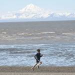 Jode Sparks runs to victory in the 10-mile mens run at the Mouth to Mouth Wild Run and Ride on Monday, May 28, 2018, at the Kenai beach. (Photo by Jeff Helminiak/Peninsula Clarion)