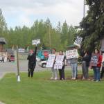 Participants in a Black Lives Matters protest hold signs at the entrance to Soldotna Creek Park along the Sterling Highway in Soldotna on Wednesday. (Photo by Brian Mazurek/Peninsula Clarion)