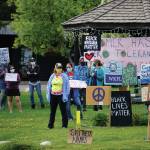 People hold signs at a protest on Sunday, May 30, 2020, at WKFL Park in Homer, Alaska, in support of people of color who have been the subject of police violence, including George Floyd, a man who died May 25, 2020, in a police encounter in Minneapolis, Minnesota. (Photo by Michael Armstrong/Homer News)