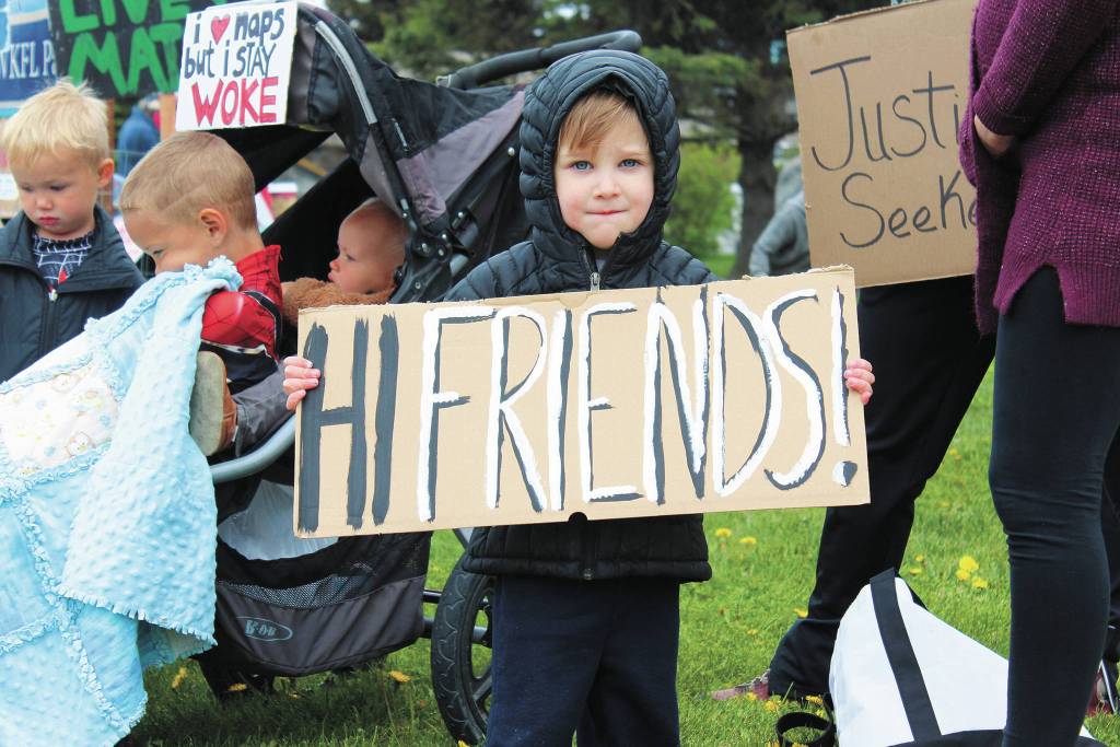 Remmik Toews, 2, holds up a sign that says Hi friends! during a Black Lives Matter demonstration on Tuesday, May 2, 2020 at WKFL Park in Homer, Alaska. (Photo by Megan Pacer/Homer News)