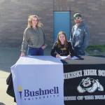 2020 Nikiski High School graduate America Jeffreys signs to play at Bushnell University in Eugene, Oregon, as Principal Dan Carstens, mother Kelly Jeffreys, father BJ Jeffreys and girls head basketball coach Rustin Hitchcock look on Wednesday, June 3, 2020. (Photo by Jeff Helminiak/Peninsula Clarion)