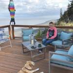 Tammy Kehrer of Palmer sits on the deck overlooking Cook Inlet at Ocean Bluff B&B in Kasilof. Kehrer is the daughter of owner Kathy Carlisle. (Photo provided by Ocean Bluff B&B)