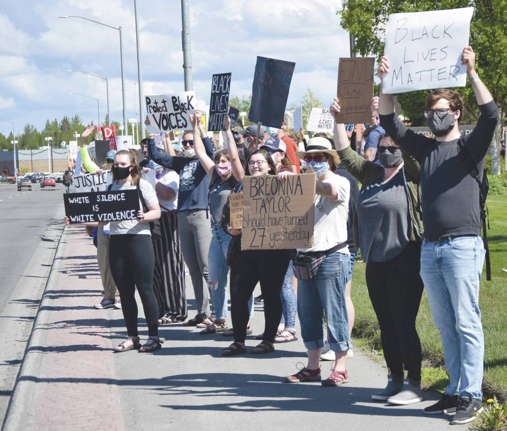 Photo by Jeff Helminiak/Peninsula Clarion                                Black Lives Matter protesters line the Sterling Highway in Soldotna, on Saturday.