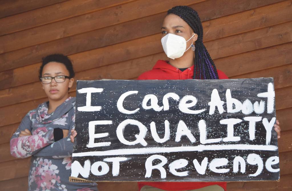 Photo by Jeff Helminiak/Peninsula Clarion                                Speakers Jazmine Henry and Shanette Jackson wait onstage at the Black Lives Matter protest at Soldotna Creek Park in Soldotna, on Saturday.