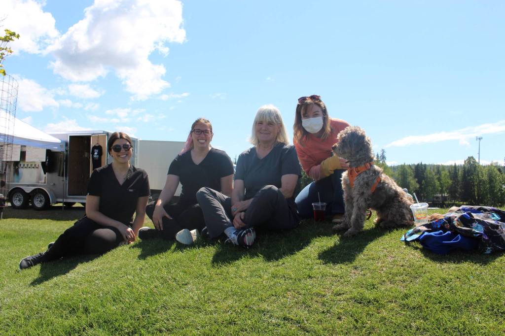 From left, Willow-Haven Walaszek, Liz Huntley, Jenny Johnson, Mary May and Oscar smile for the camera during the Wednesday Market at Soldotna Creek Park in Soldotna, Alaska on June 10, 2020. (Photo by Brian Mazurek/Peninsula Clarion)