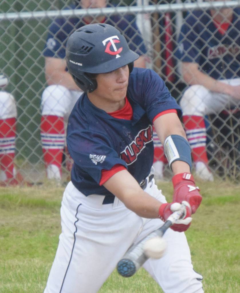 Photo by Jeff Helminiak/Peninsula Clarion                                Alaska 20s Jacob Belger smacks a single to right field Tuesday at Kenai Little League fields in Kenai.