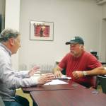 Tim Dillon, executive director of the Kenai Peninsula Economic Development District, helps Doug Weaver, owner of Northern Superior Construction, apply for an AK CARES grant through Credit Union 1 at the KPEDD office in Kenai on Wednesday. (Photo by Brian Mazurek/Peninsula Clarion)