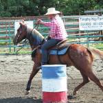 Naida McGee leads her horse through the barrel race at this years Ninilchik Rodeo on Saturday, July 4, 2020 at the Kenai Peninsula Fairgrounds in Ninilchik, Alaska. (Photo by Megan Pacer/Homer News)