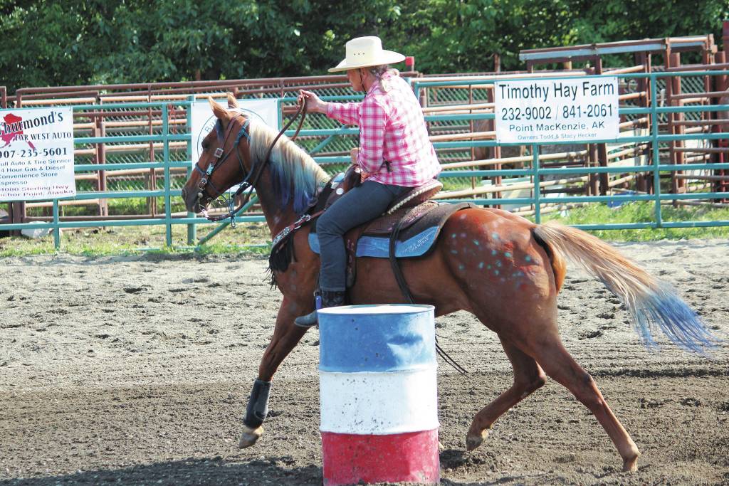 Naida McGee leads her horse through the barrel race at this years Ninilchik Rodeo on Saturday, July 4, 2020 at the Kenai Peninsula Fairgrounds in Ninilchik, Alaska. (Photo by Megan Pacer/Homer News)