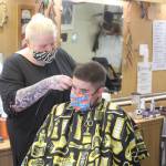 Skylar Giordano cuts Ryan Huertas hair at RDs Barber Shop in Kenai, Alaska on Thursday, July 9, 2020. RDs is one of the 186 local businesses and nonprofits in Kenai that already received financial assistance through the City of Kenais Grant Program. (Photo by Brian Mazurek/Peninsula Clarion)